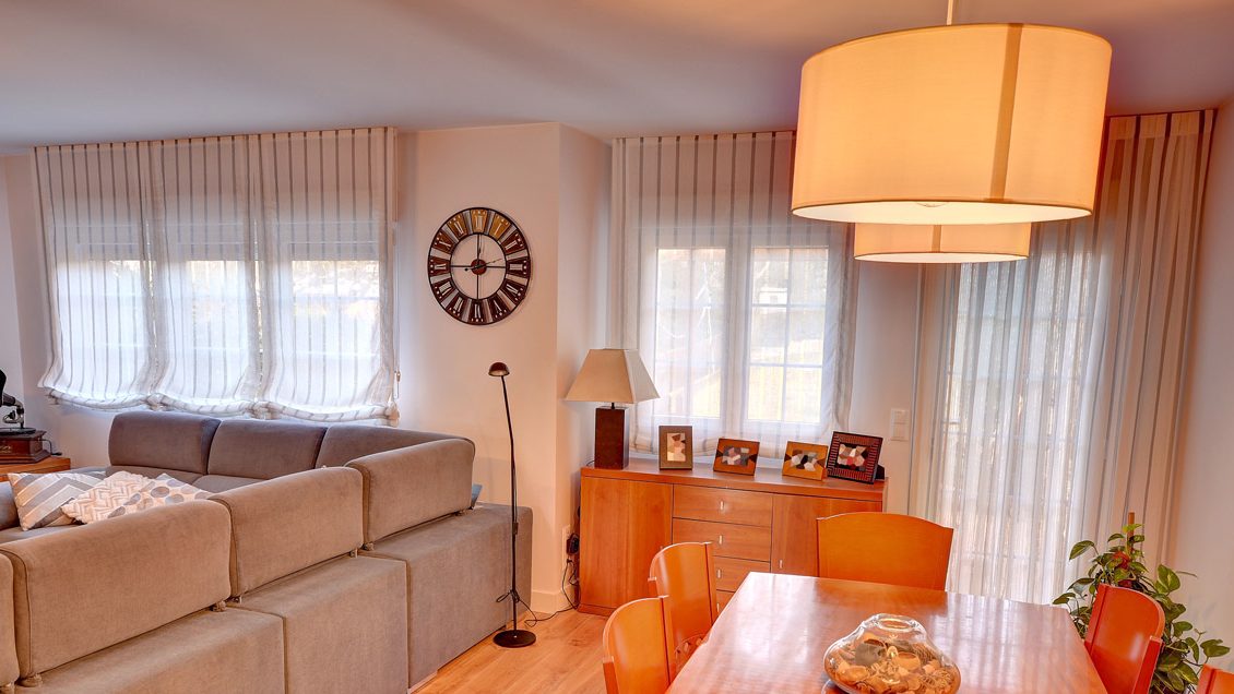 Estores de paquete con cortinas de tablas en un salón comedor